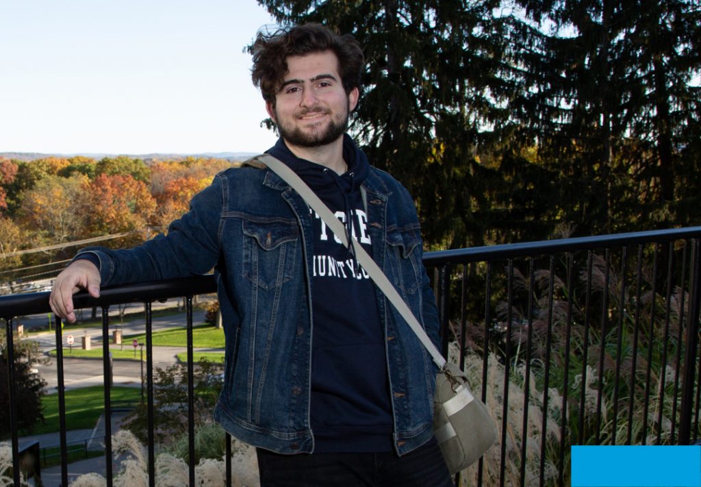 student smiling at camera on campus